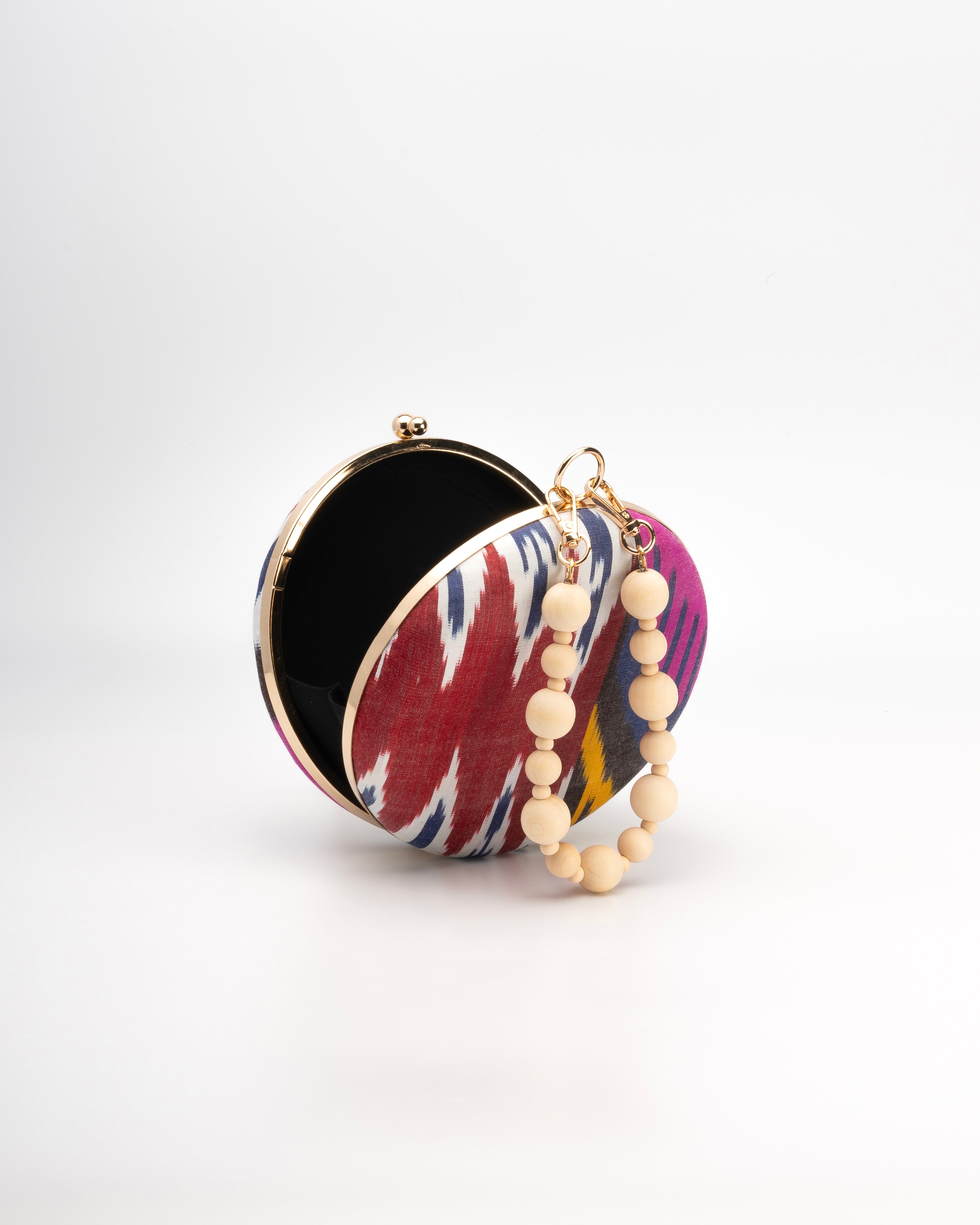 Frankitas handwoven silk Ikat round clutch in rich, multicolor pattern—each piece uniquely crafted