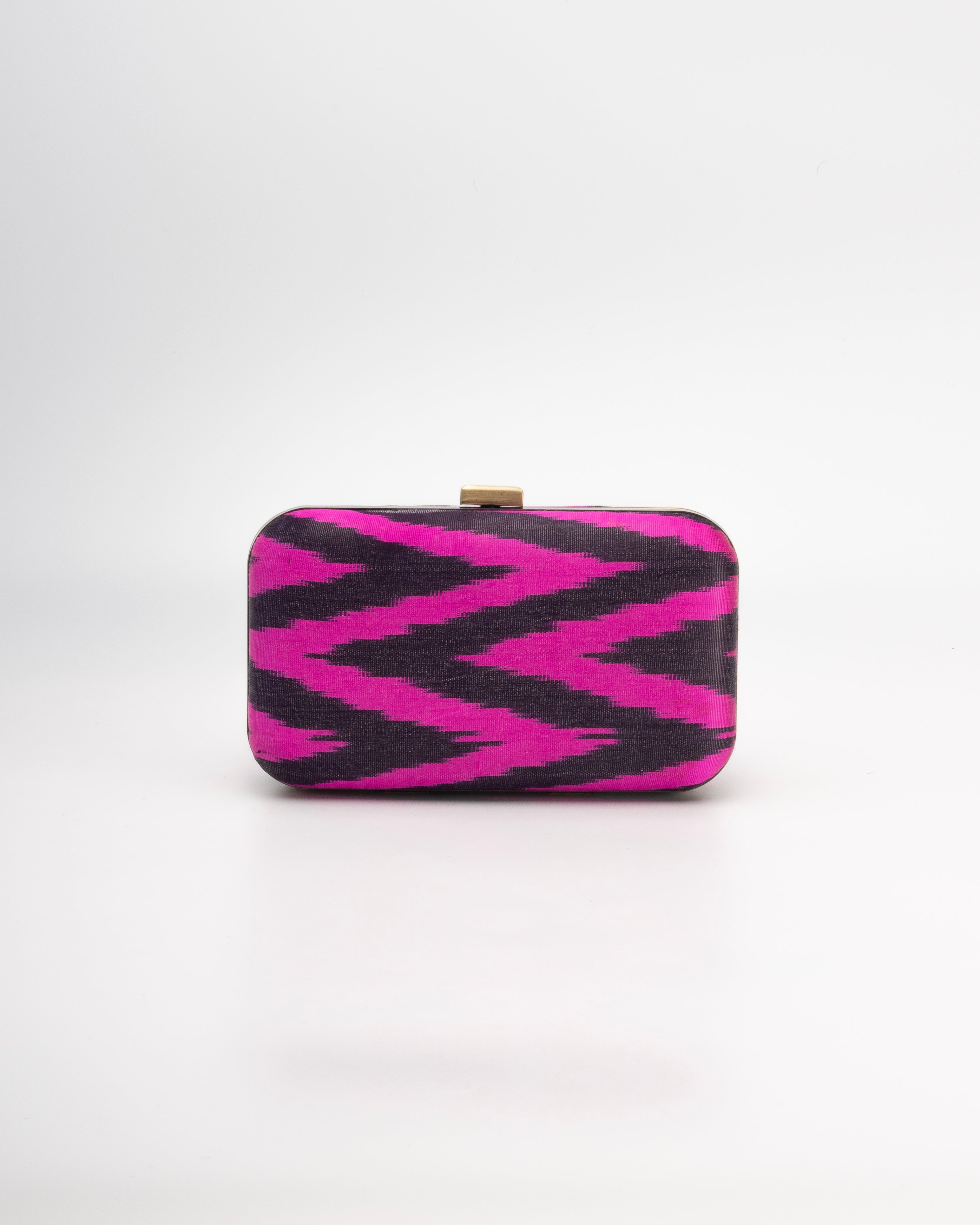 Frankitas Tasia box clutch featuring timeless chevron pattern in handwoven fuchsia and black artisanal fabric