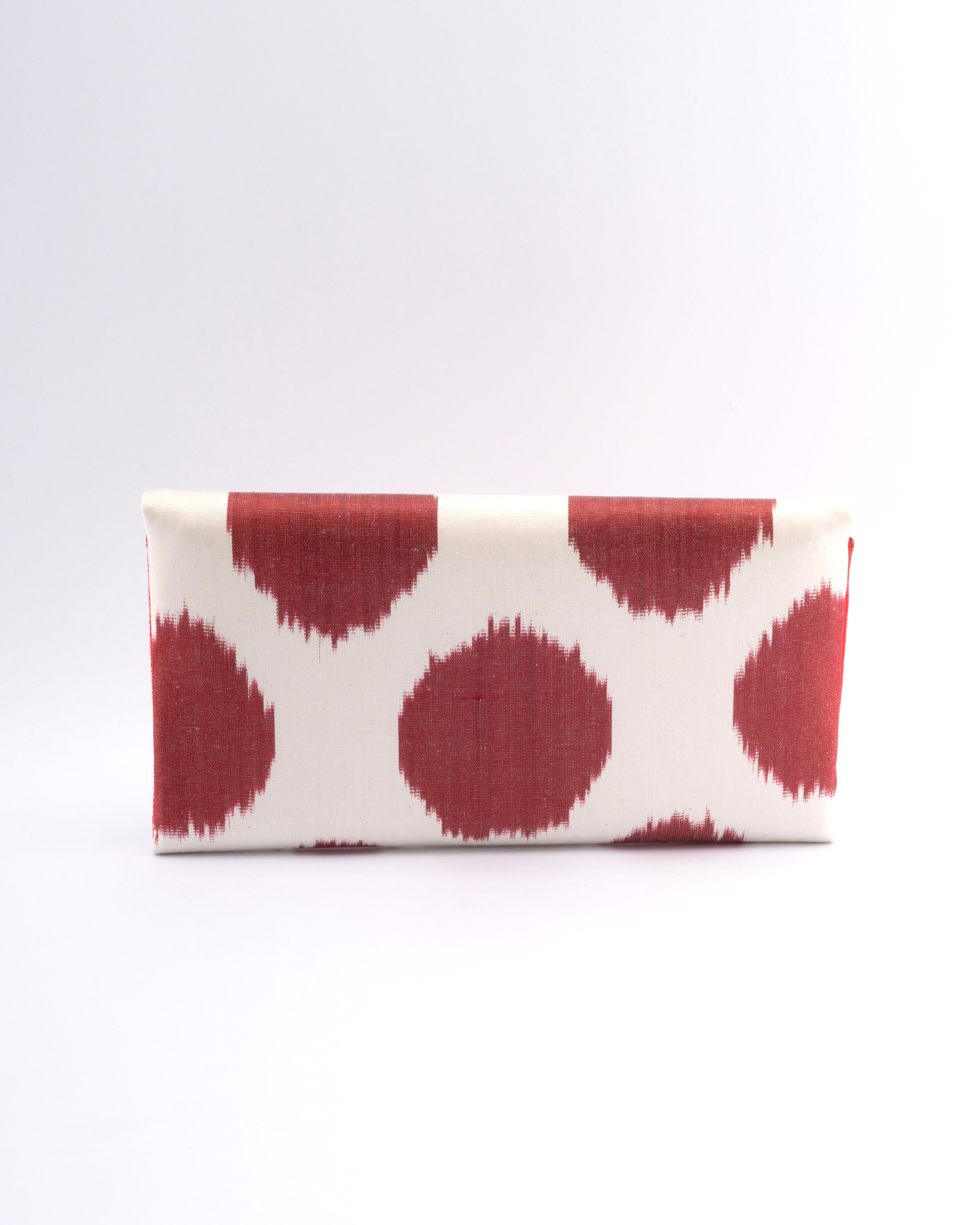 Frankitas’ iconic envelope clutch the Titin brings traditional silk ikat weaving into a sleek, classic silhouette of red and white polka dot