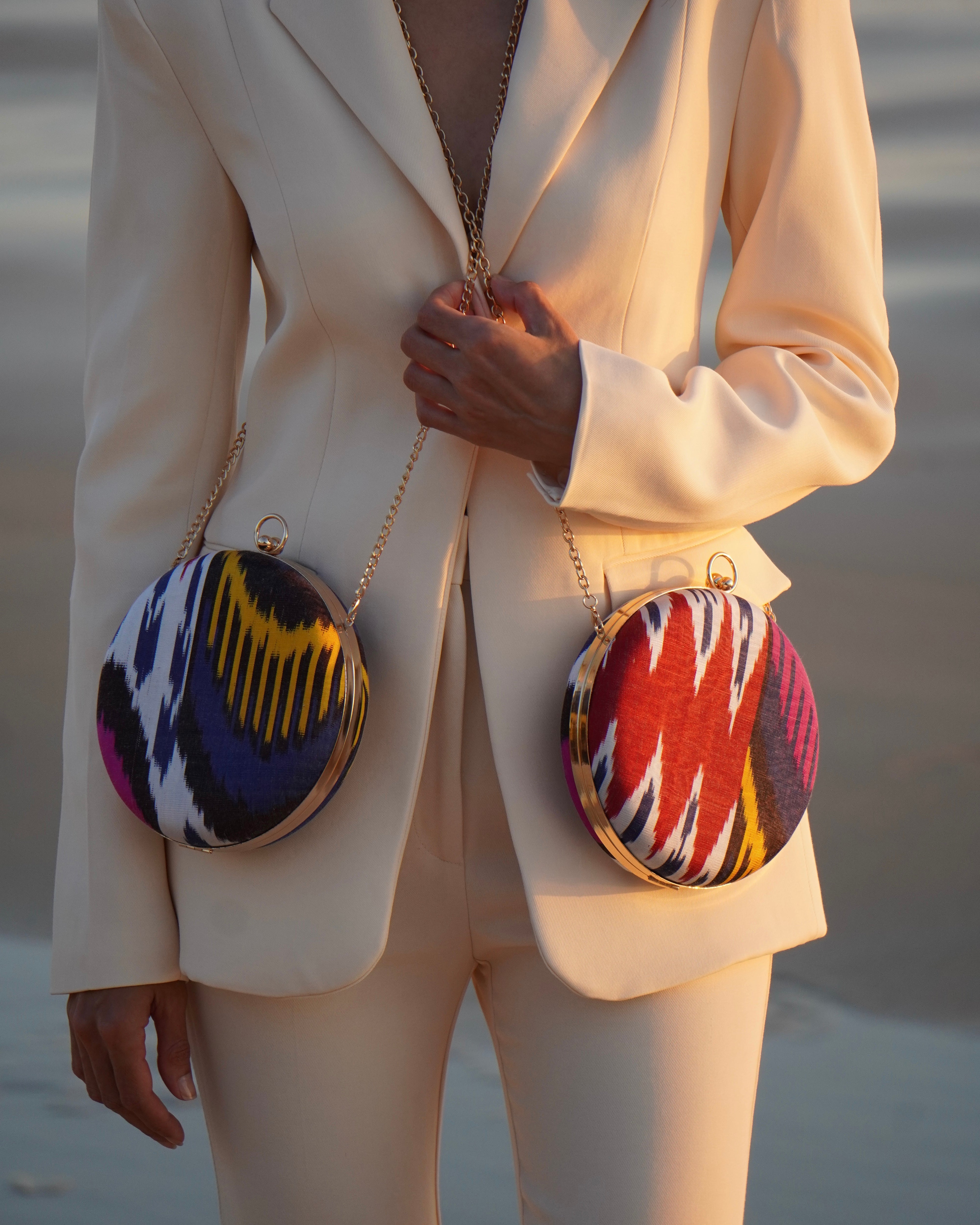 Artisan crossbody bags honoring heritage in Central Asian textile - Silk handwoven ikat - on a Frankitas Puteri round classic clutch.
