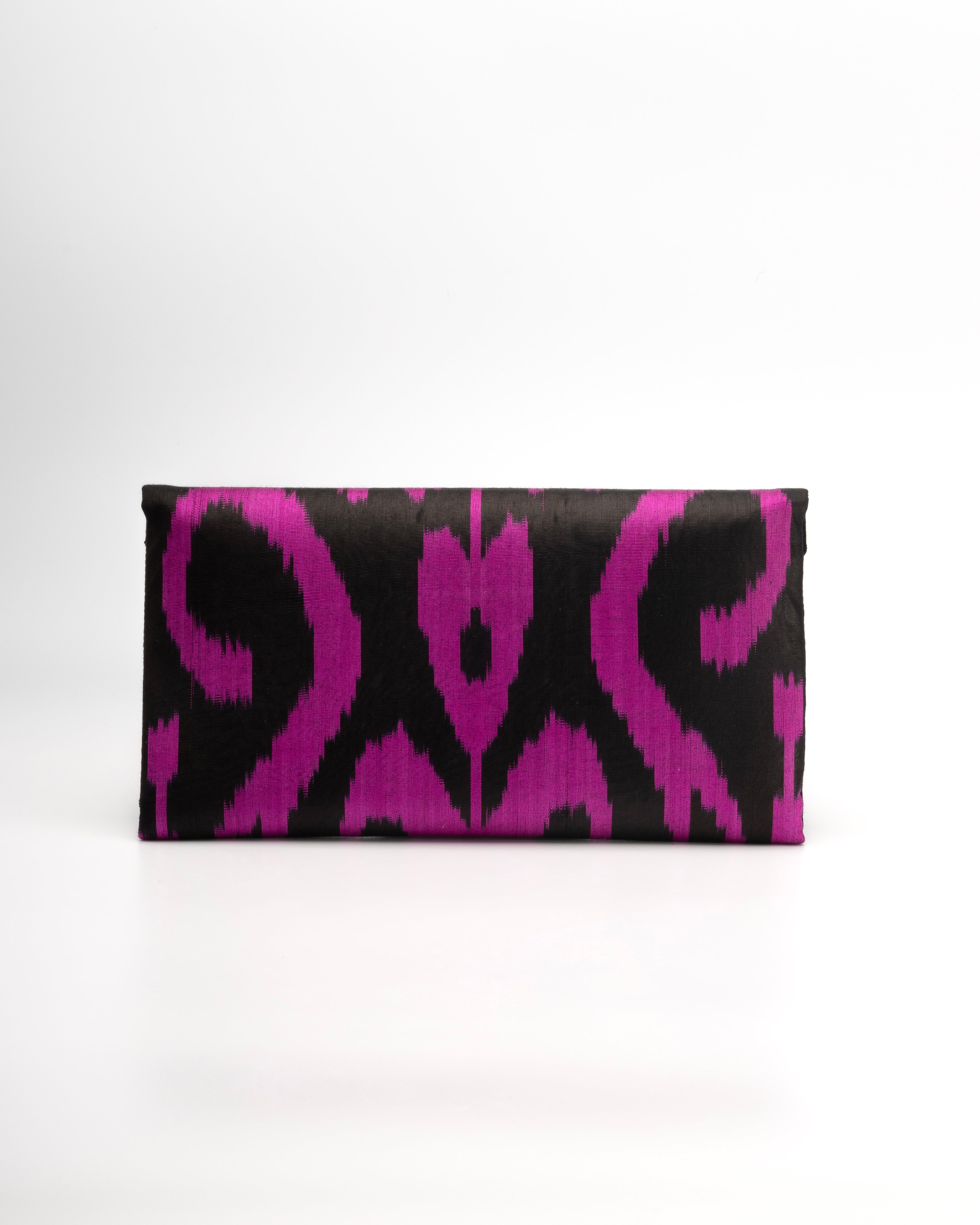 Black clutch with pink abstract pattern silk ikat handwoven envelope clutch handbag - With a nod to tradition, Frankitas' classic envelope clutch is adorned in beautifully handwoven silk ikat.