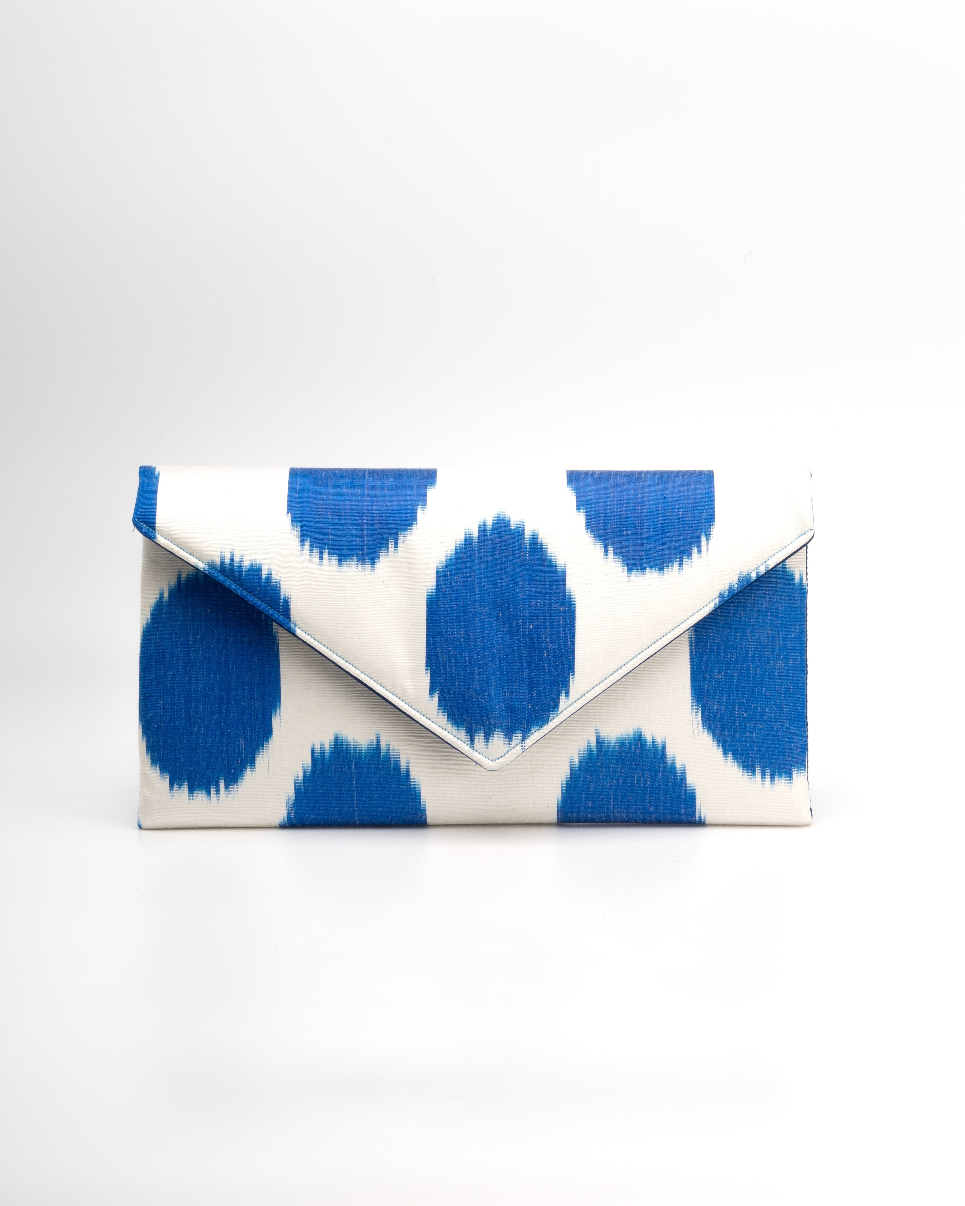Artisanal envelope clutch blending hand‑loomed Central Asian Ikat with classic polka‑dot style