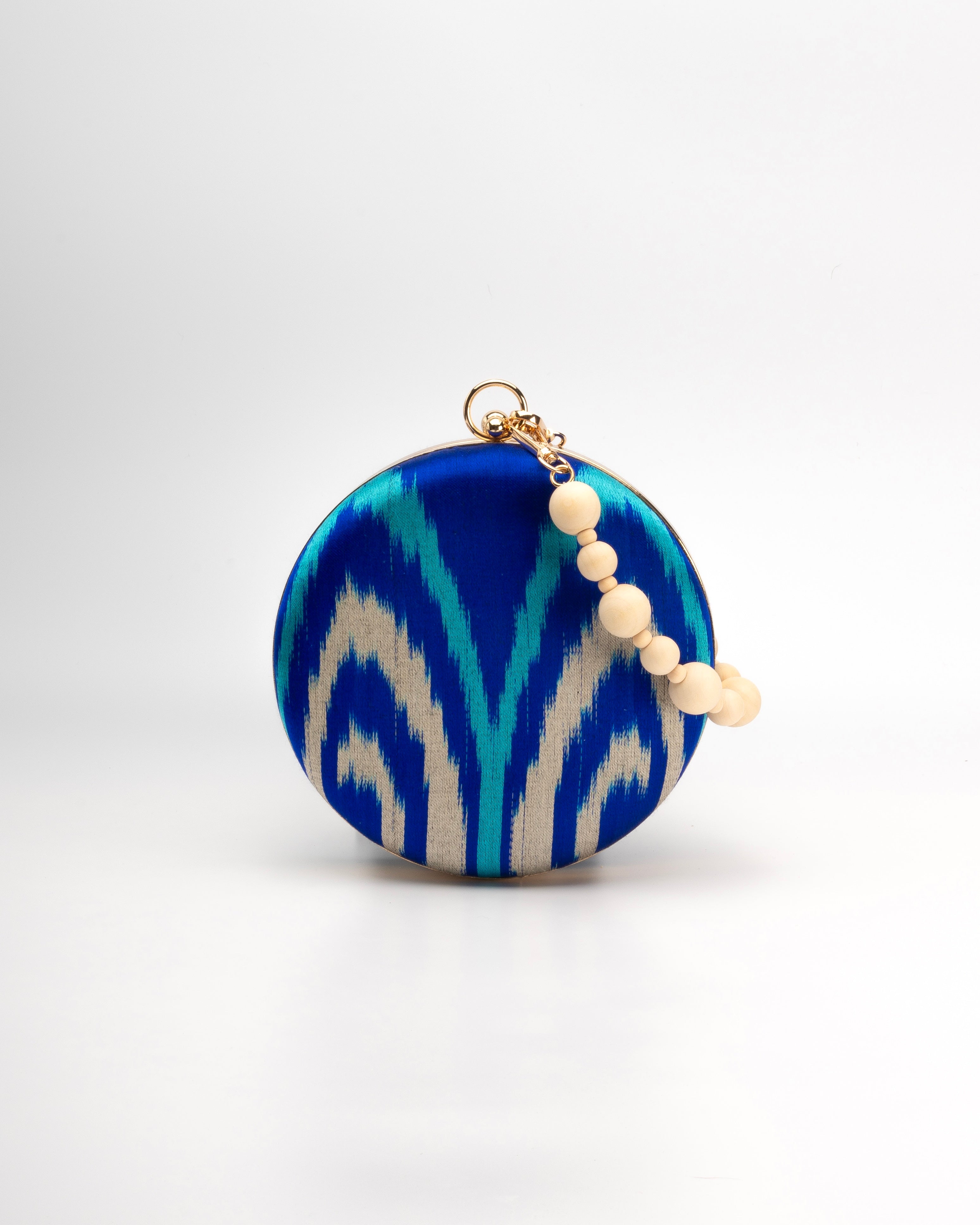 Frankitas classic deep blue Cobalt, turquoise and beige Puteri handwoven silk ikat clutch handbag with a light wodden beaded strap