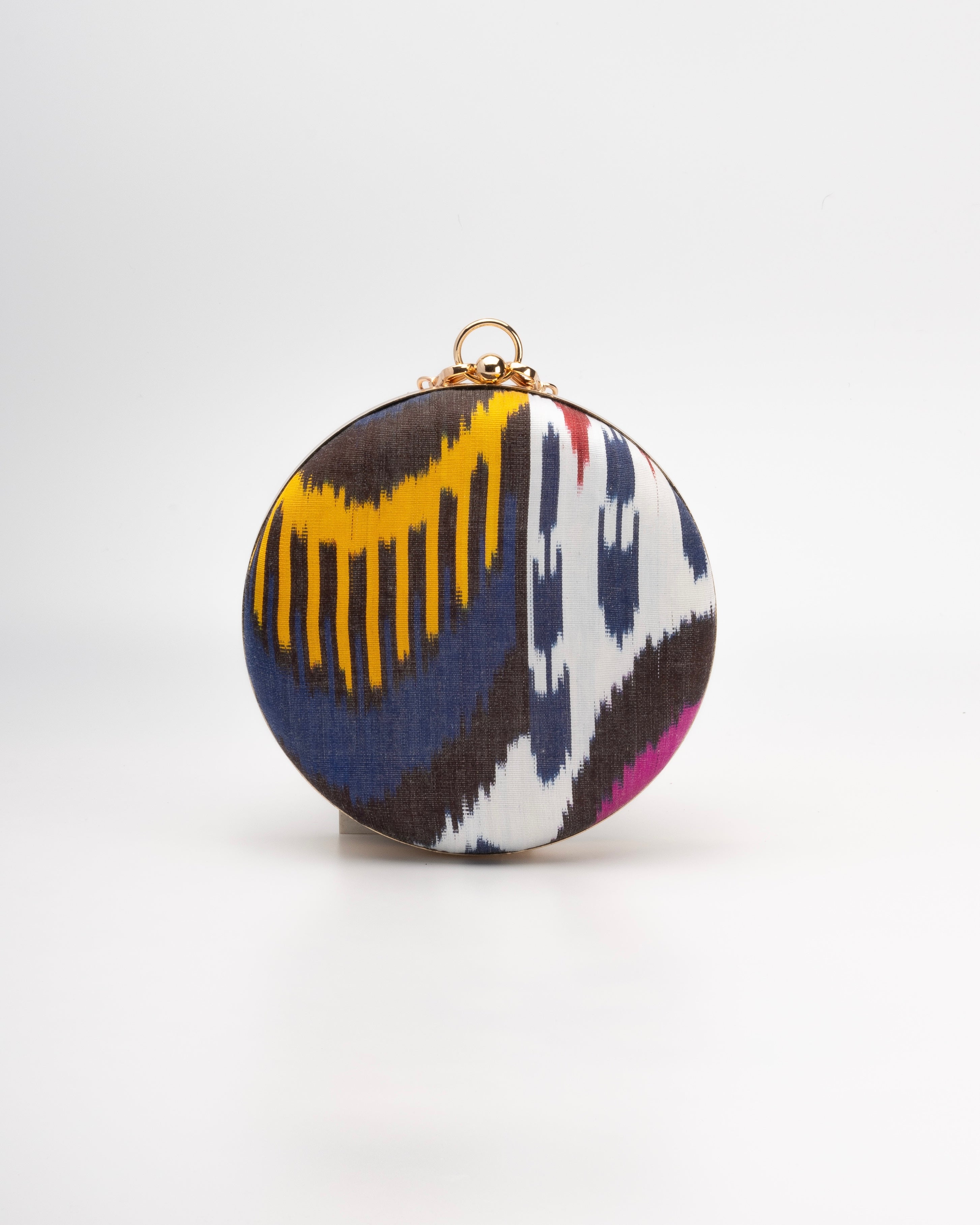 Heritage‑inspired Frankitas circular clutch in vibrant hand‑woven silk Ikat—artisan‑made and one‑of‑a‑kind