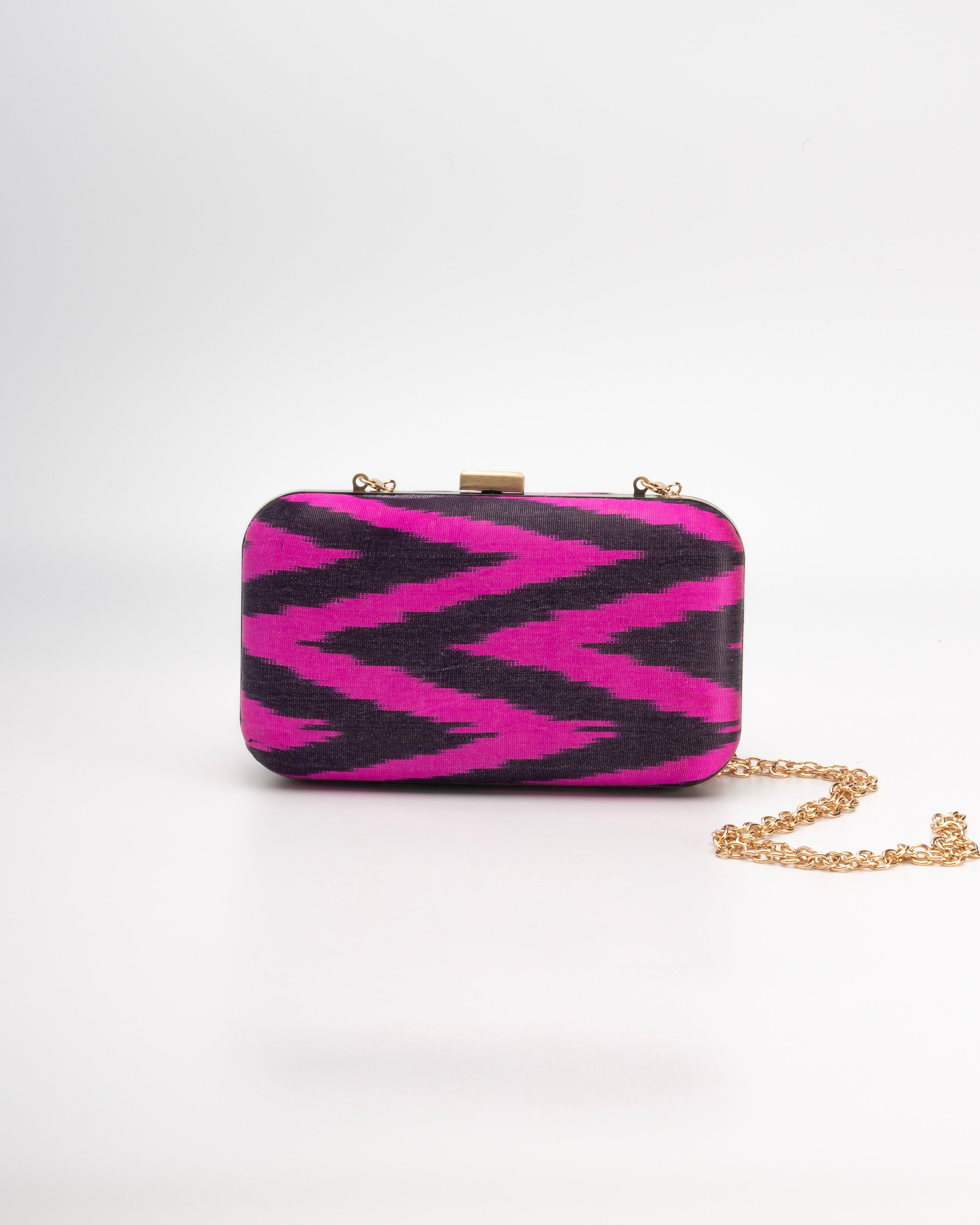 Artisan-made Frankitas clutch with bold fuchsia and black chevron textile in structured box silhouette