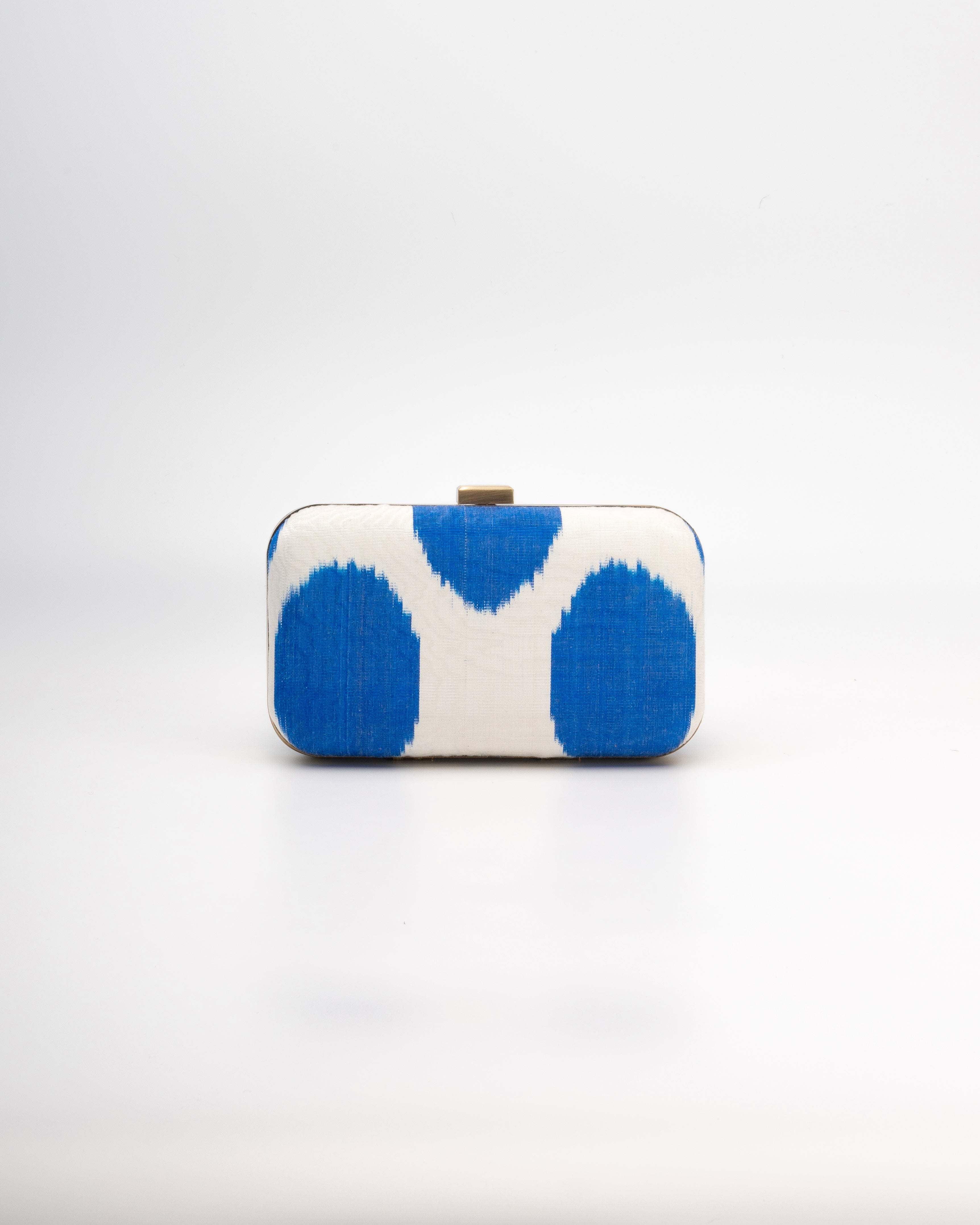 Frankitas classic rectangle clutch handbag featuring the beauty of handwoven silk ikat with a deep blue and white polka dot pattern 