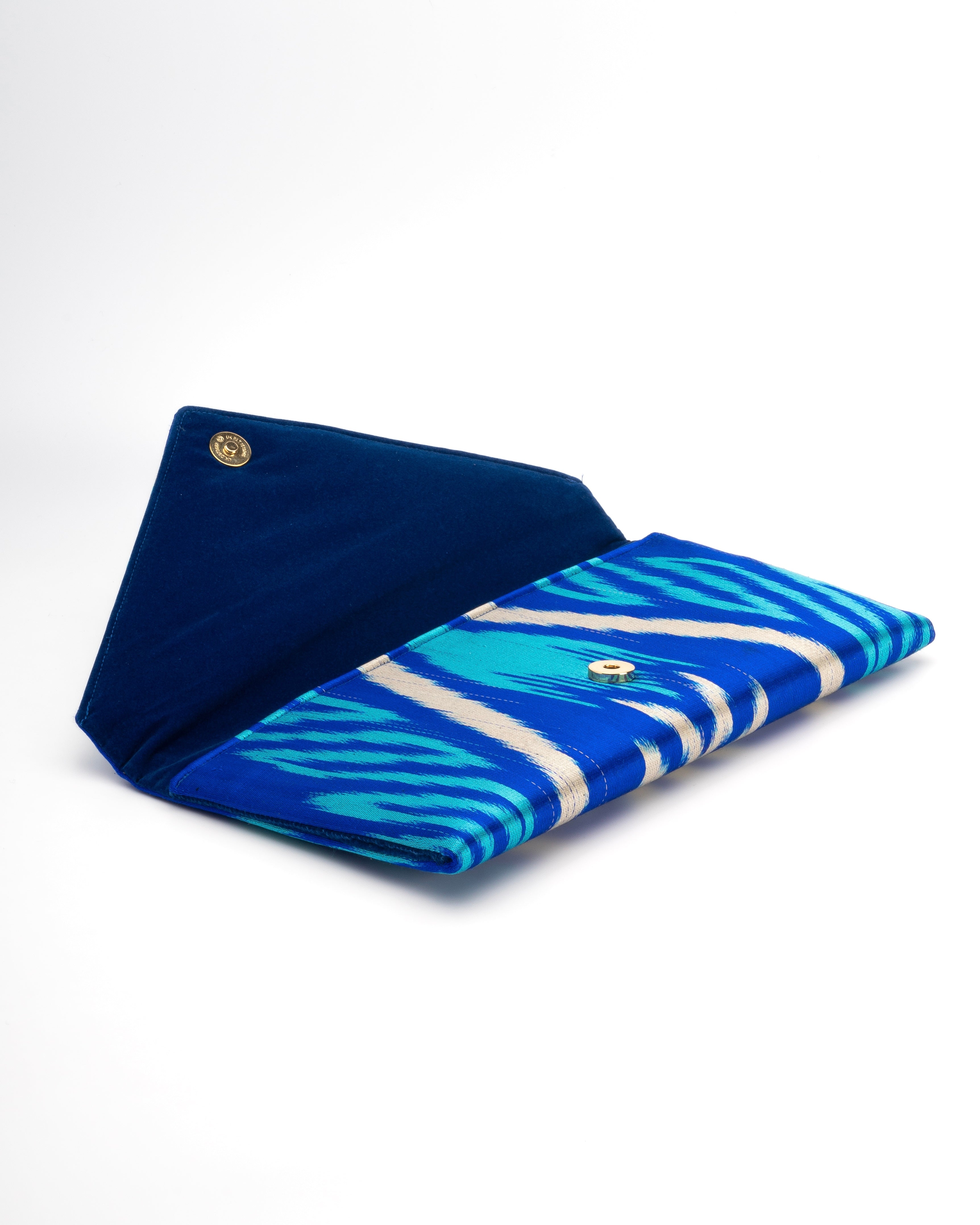 Frankitas envelope bag in bold blue and teal Ikat textile, reflecting Asian weaving heritage