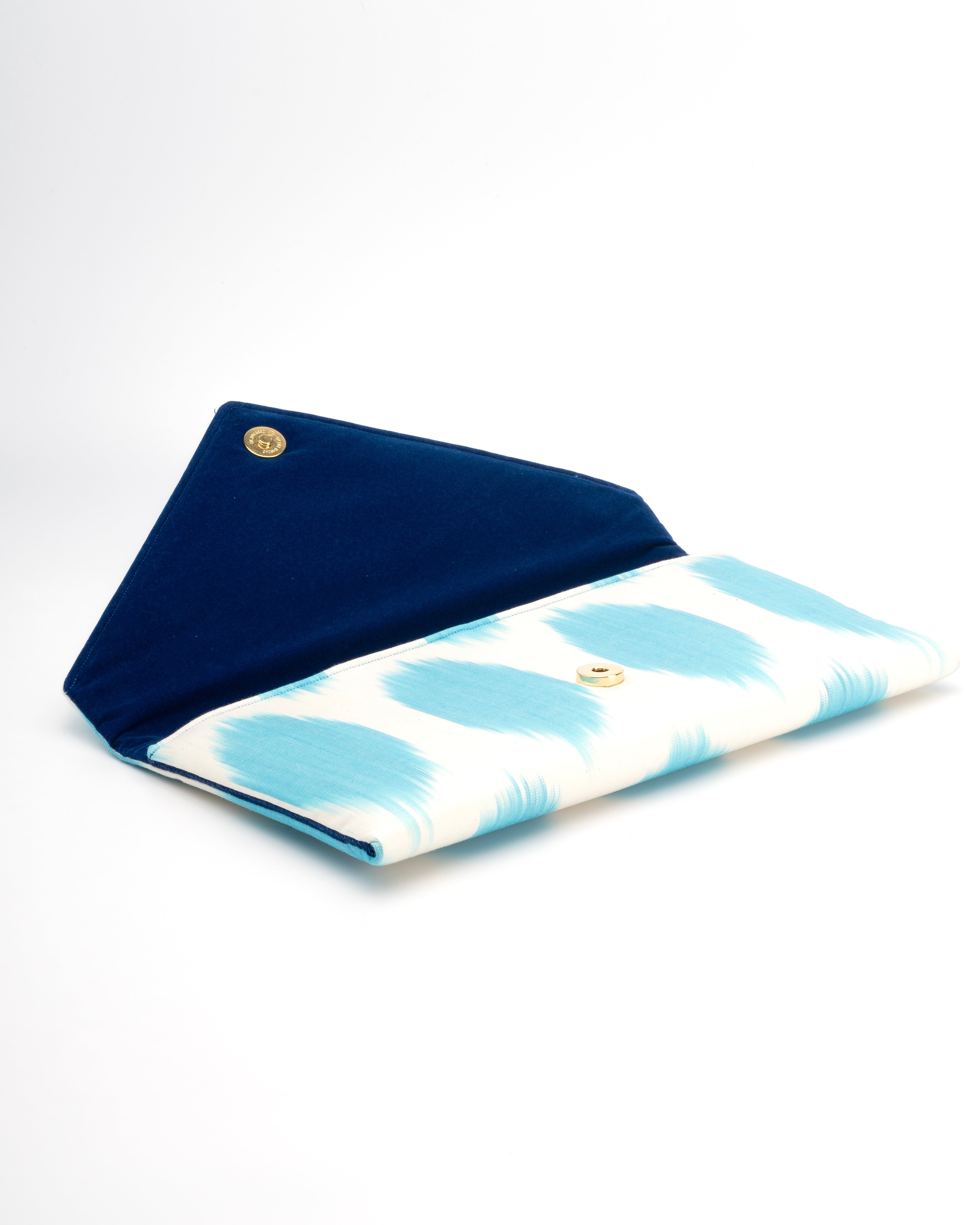 Handcrafted Frankitas envelope clutch in silk Ikat, combining Central Asian weaving with playful dots