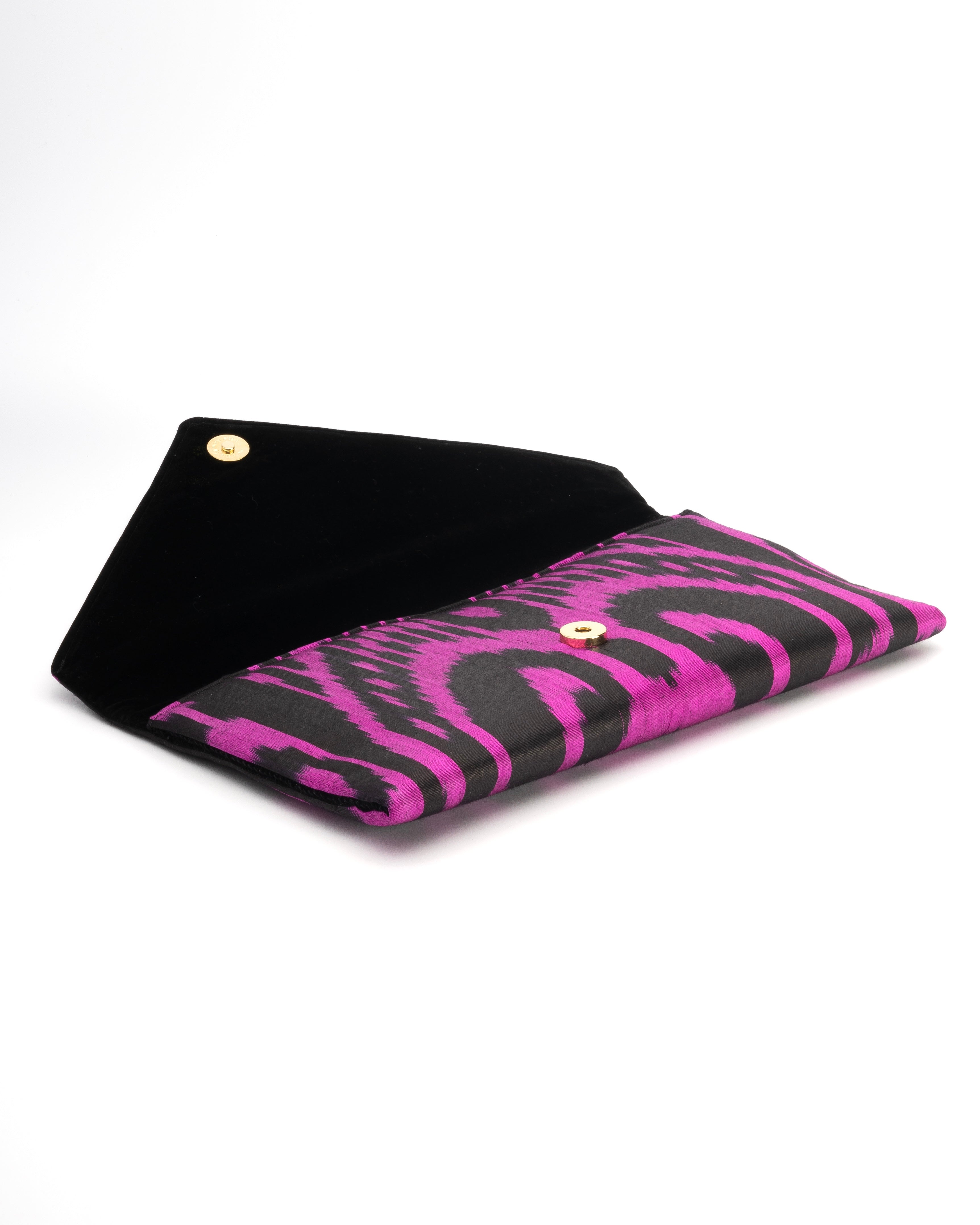 Envelope clutch showcasing hand‑loomed silk Ikat with tribal design—artisan-crafted by Frankitas