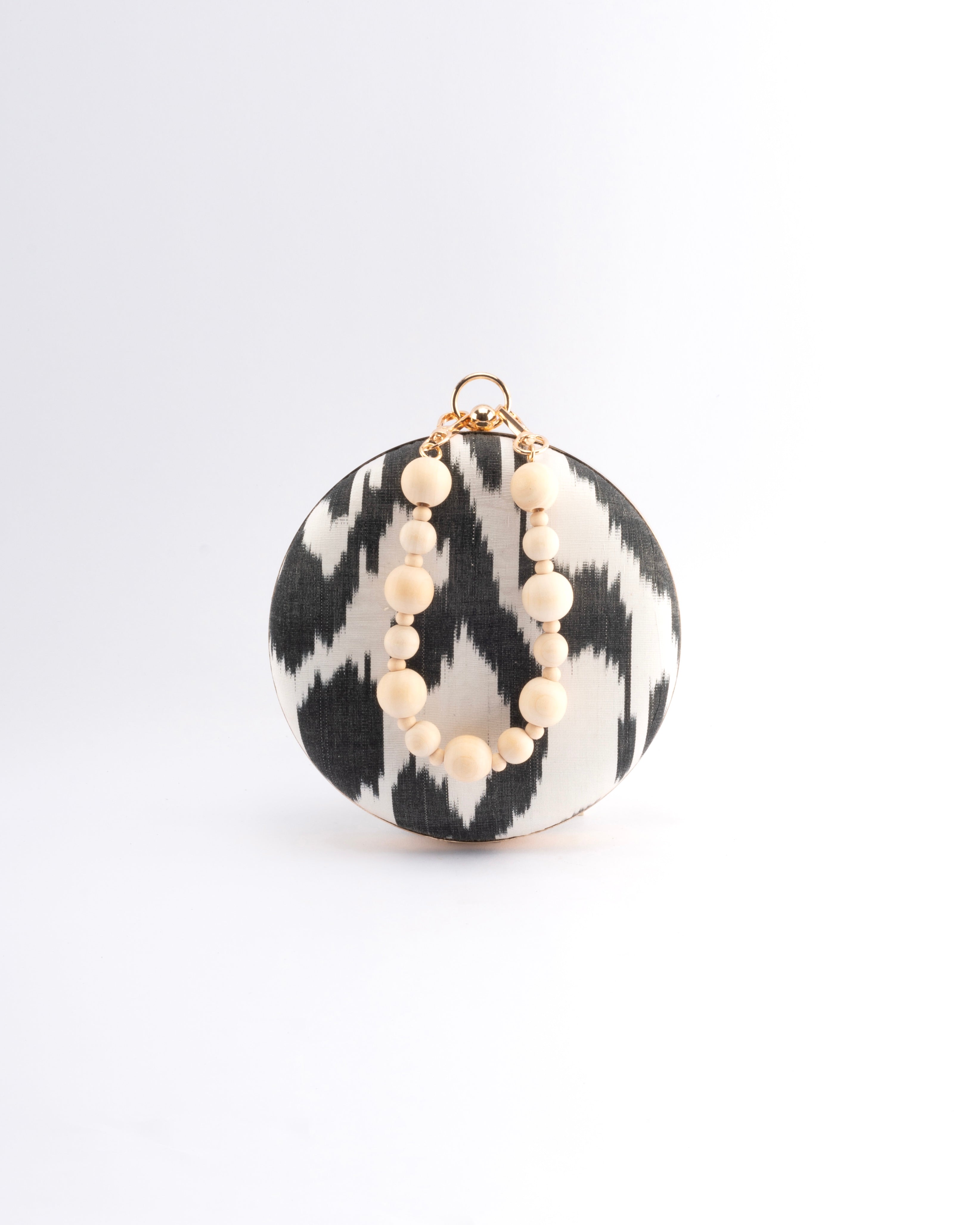 Frankitas round Puteri clutch handcrafted from hand-loomed Uzbek silk Ikat in bold heritage patterns