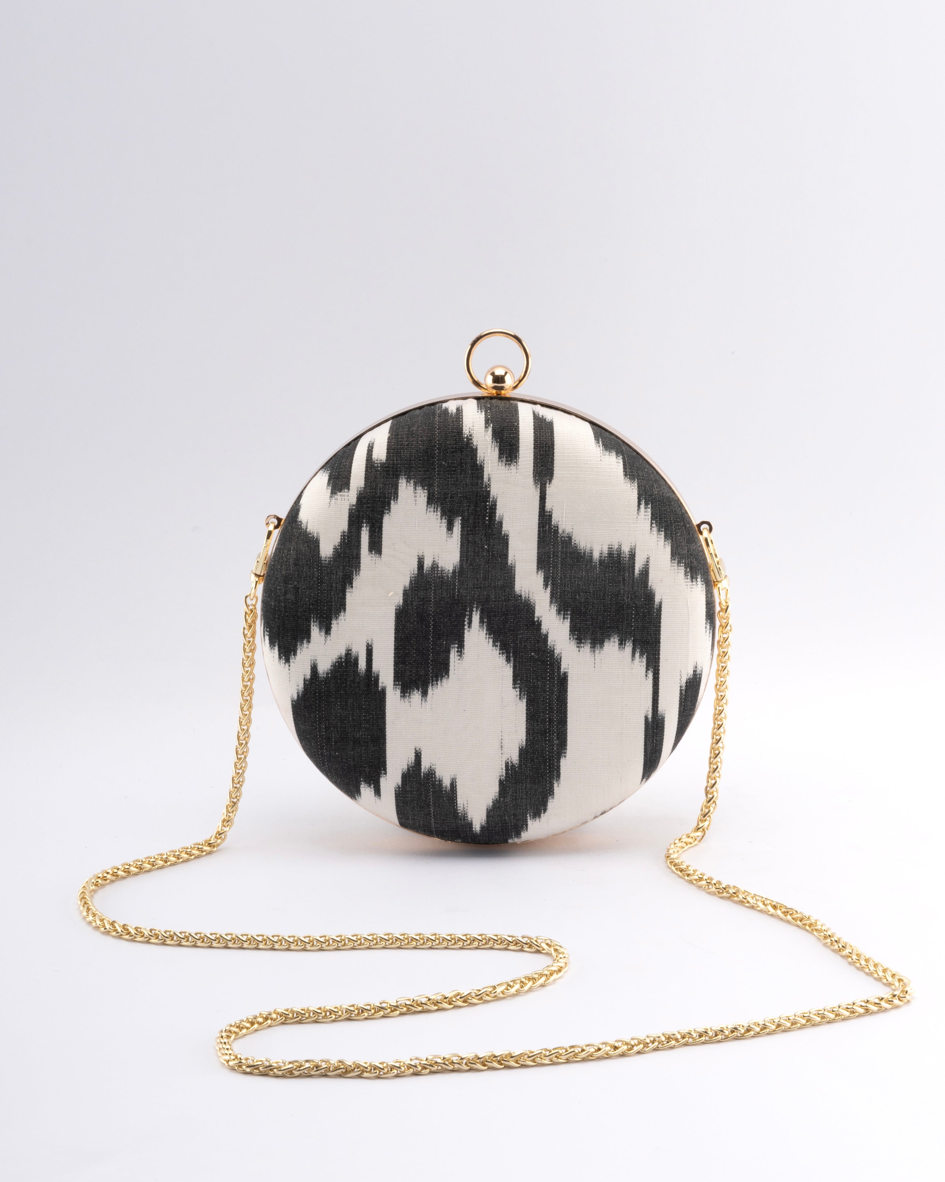 Luxury round clutch made of hand-dyed silk Ikat, crafted by Frankitas artisans from Central Asia