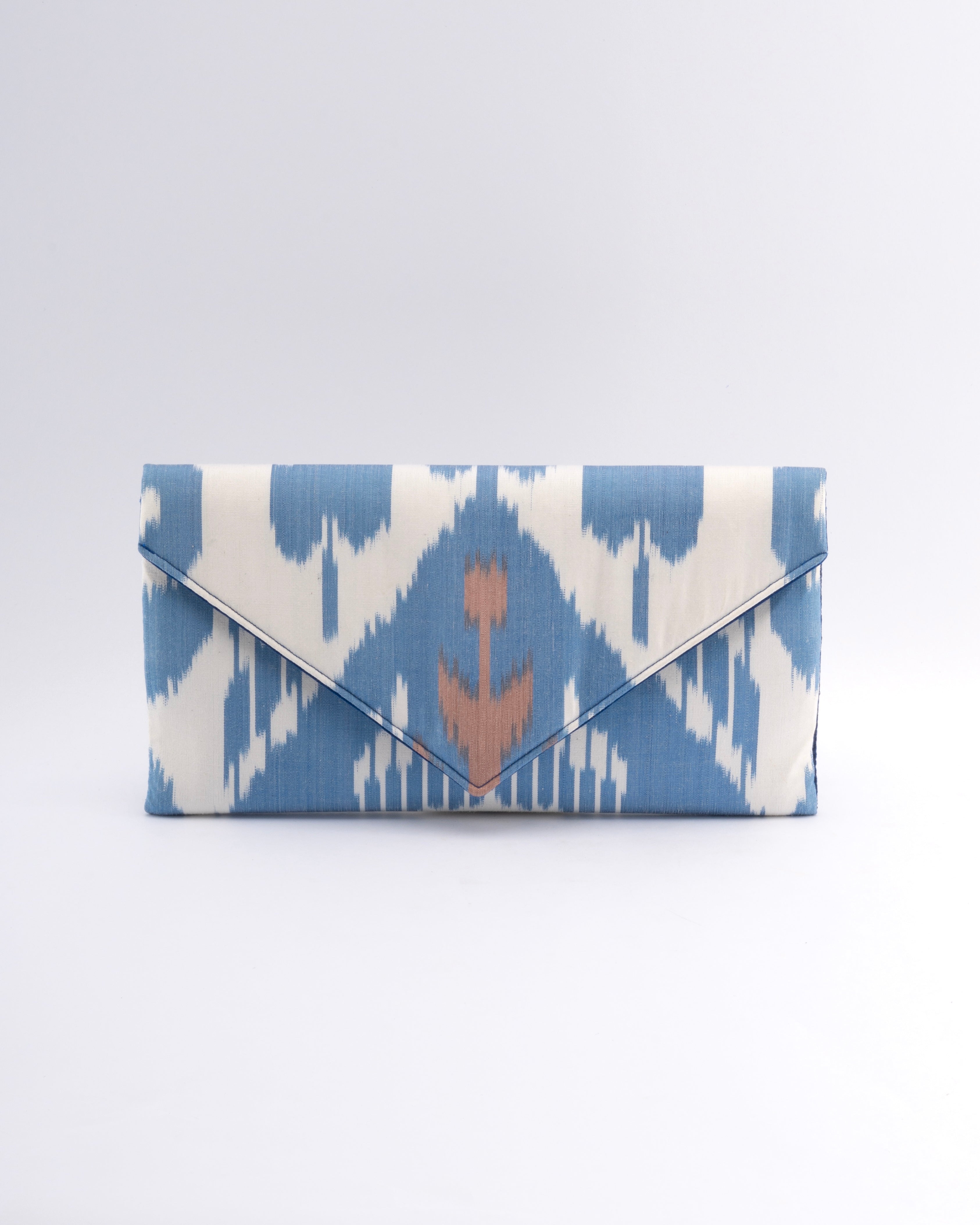 Frankitas heritage in textile Uzbekistan silk ikat featured on a classic envelope Blue and white patterned clutch bag with a brown flower design