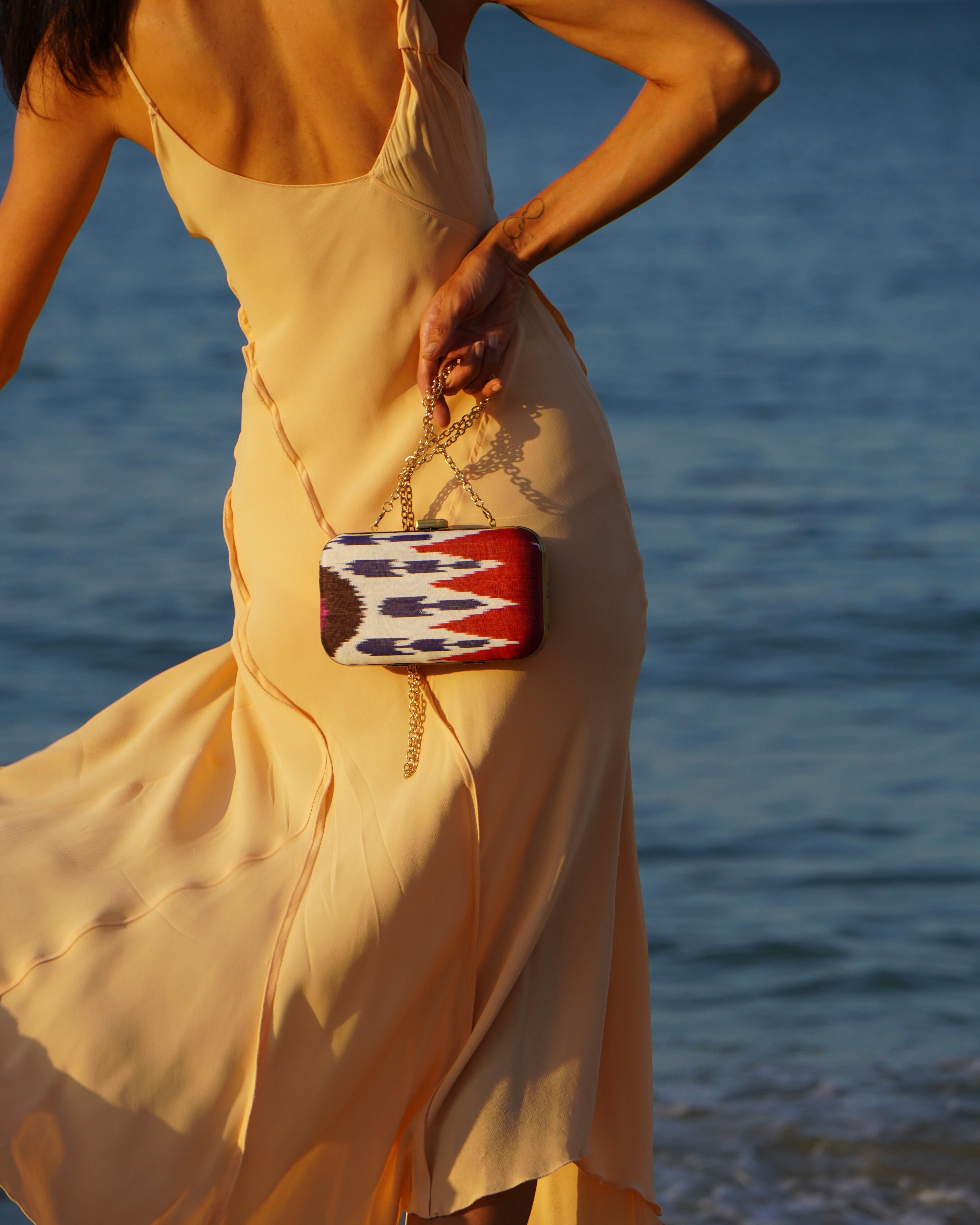 Cultural fusion clutch by Frankitas with red, white, and navy Ikat pattern in handcrafted silk