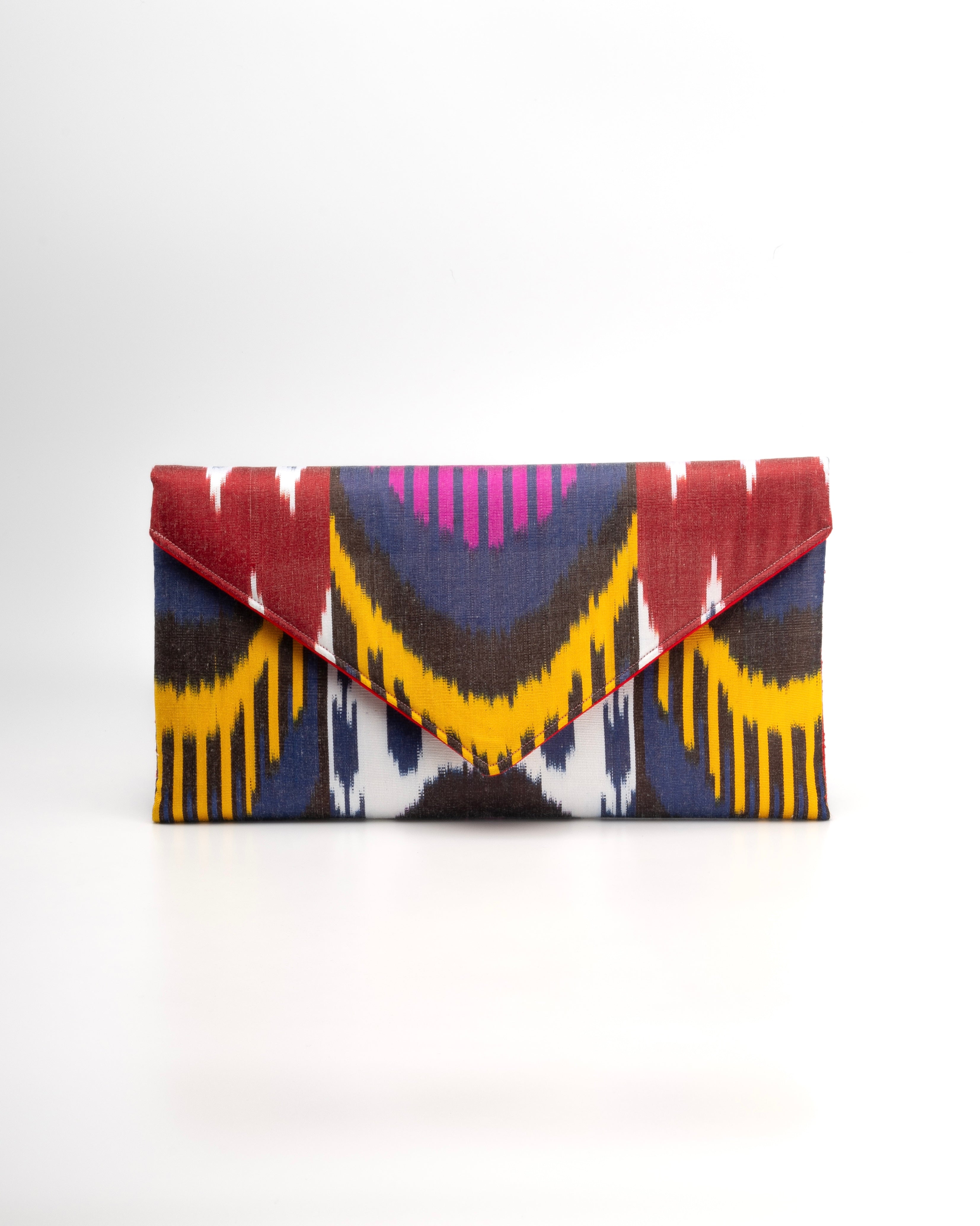 Handcrafted from 100% hand-woven silk Ikat Frankitas signature classic envelope clutch is a celebration of Asian artistry and thoughtful design. 