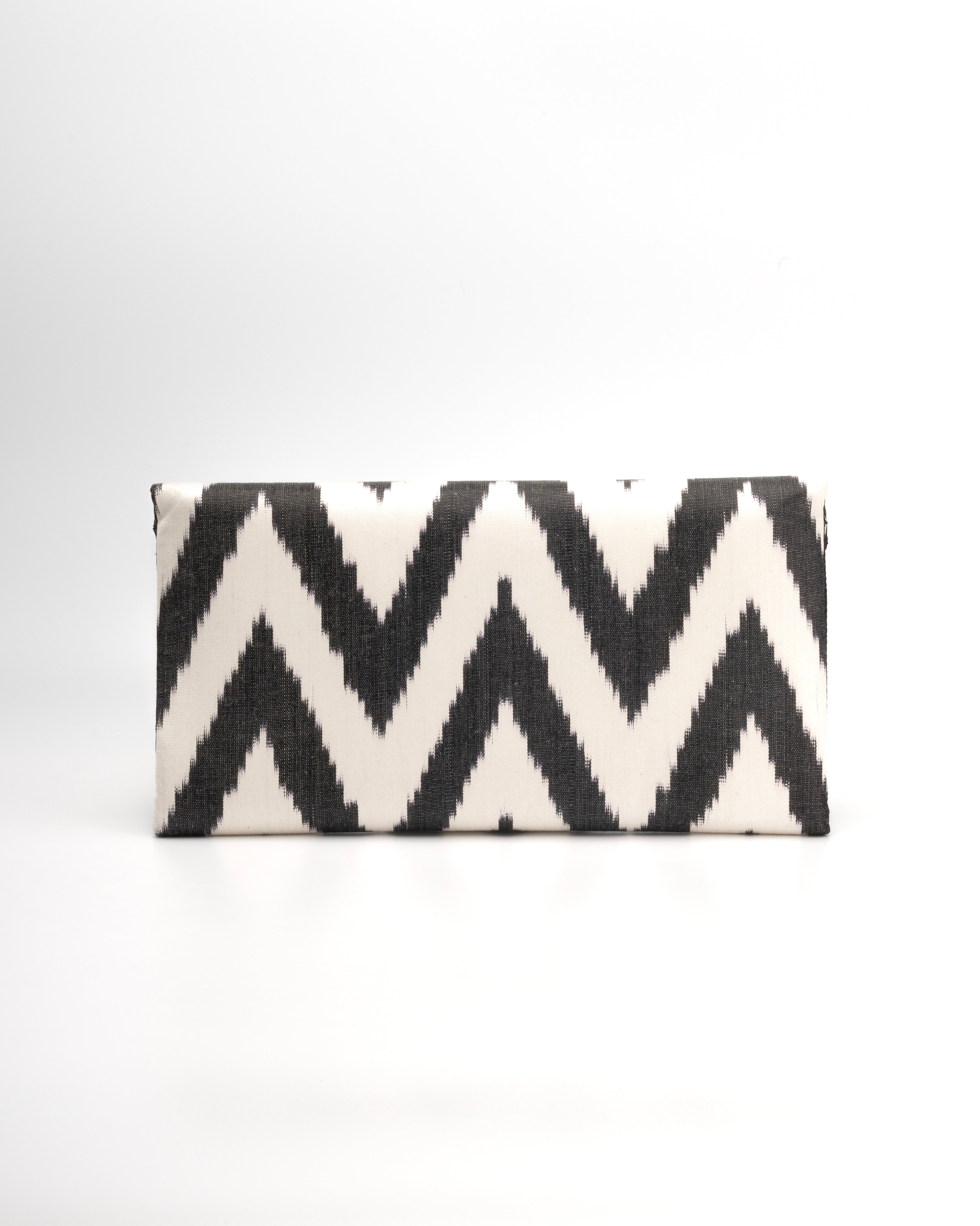 Envelope-style clutch in a classic blakc and white silk Ikat in bold chevron pattern by Frankitas