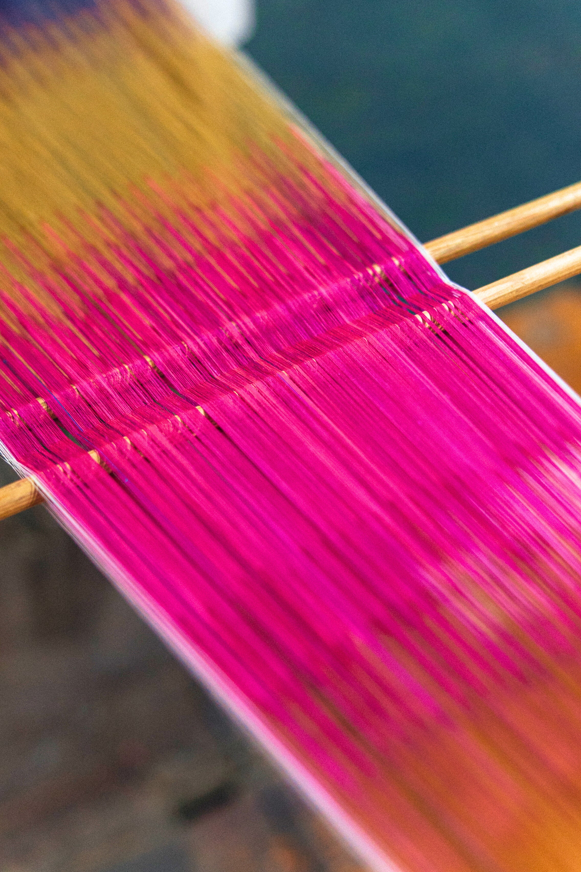 Close-up of colorful yarn on a loom in making silk ikat for Frankitas
