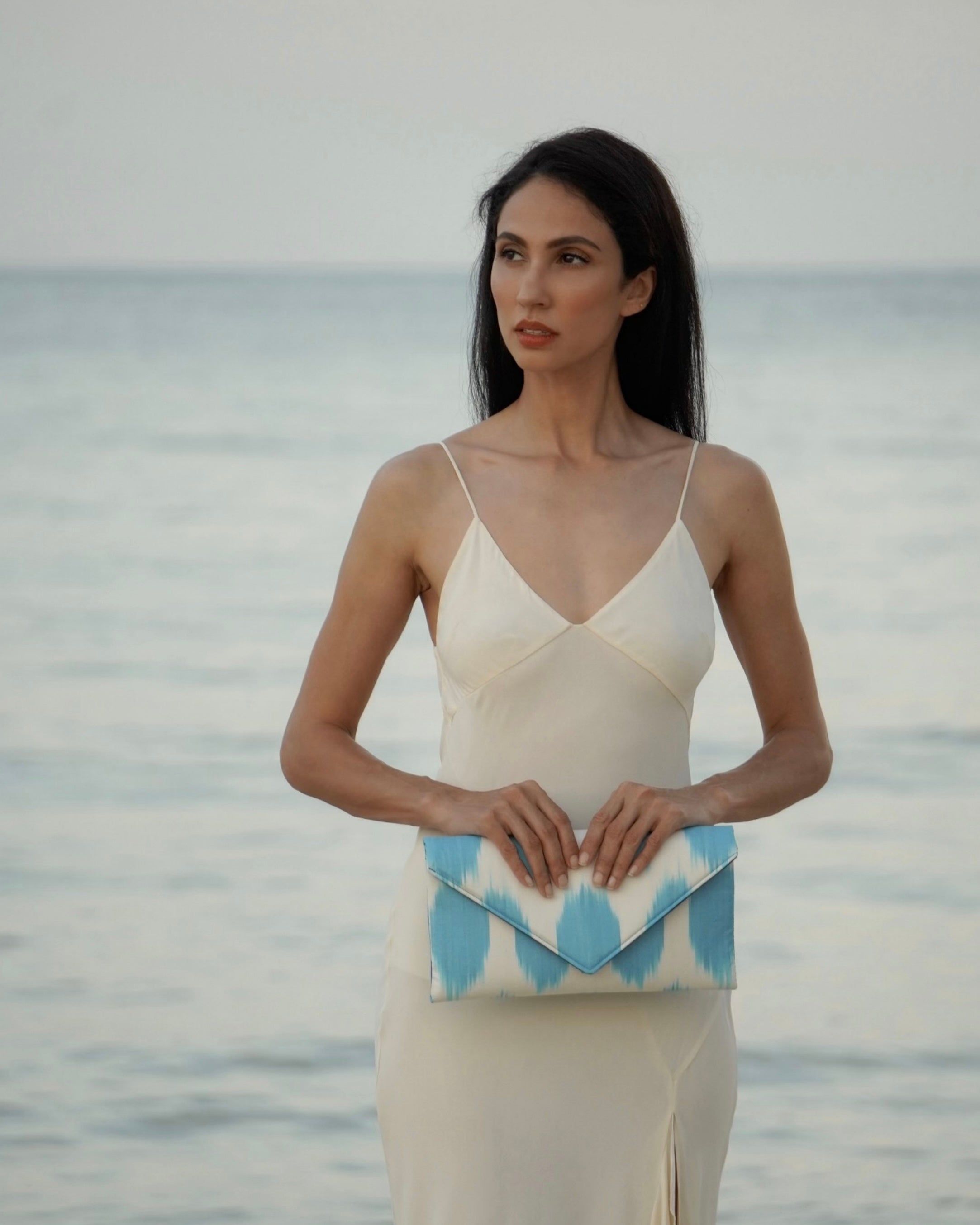 Contemporary envelope clutch featuring heirloom silk Ikat from Central Asia and classic polka-dot detail